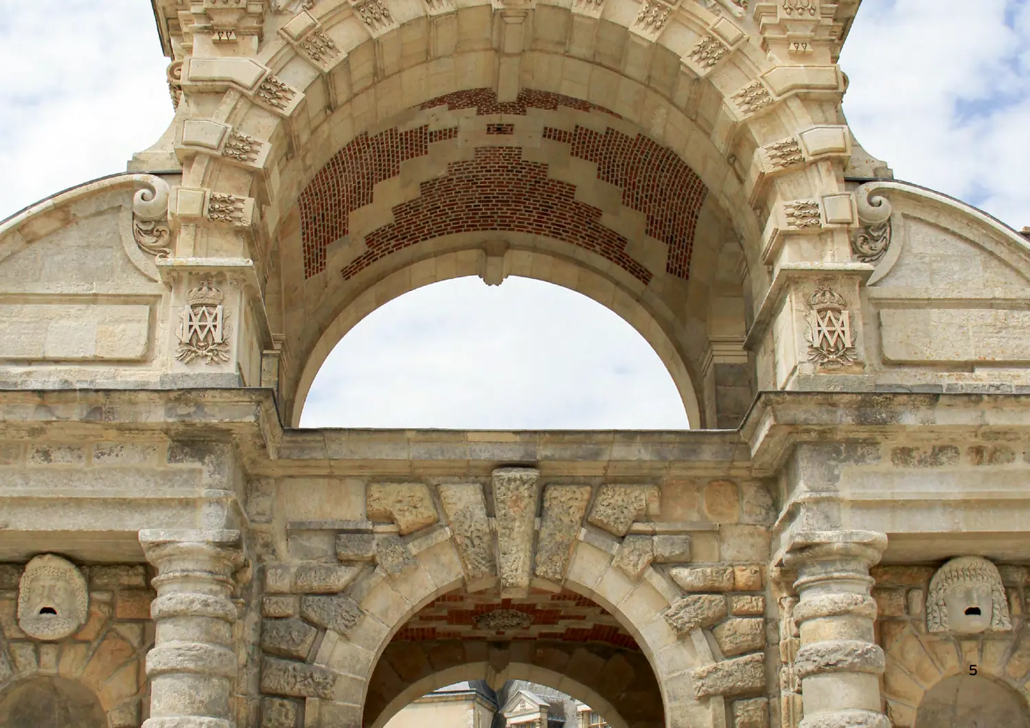The archway at Fontainebleau where the monogram is carved, as it appears in the Style Guide